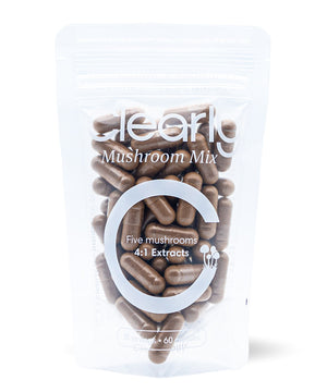 Clearly Mushroom Mix capsules displayed in a bottle, featuring a variety of mushroom supplements in capsule form.